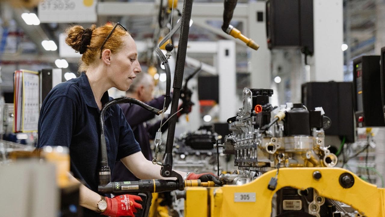An engineer working with production equipment in a manufacturing environment